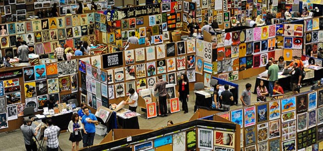A photo of many posters covering temporary walls at the Flatstock poster convention from SXSW Flatstock 2011